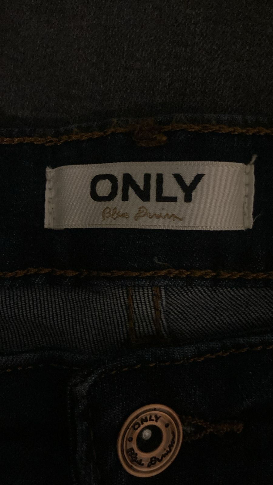 Close-up of ONLY brand label and branded button on the jeans
