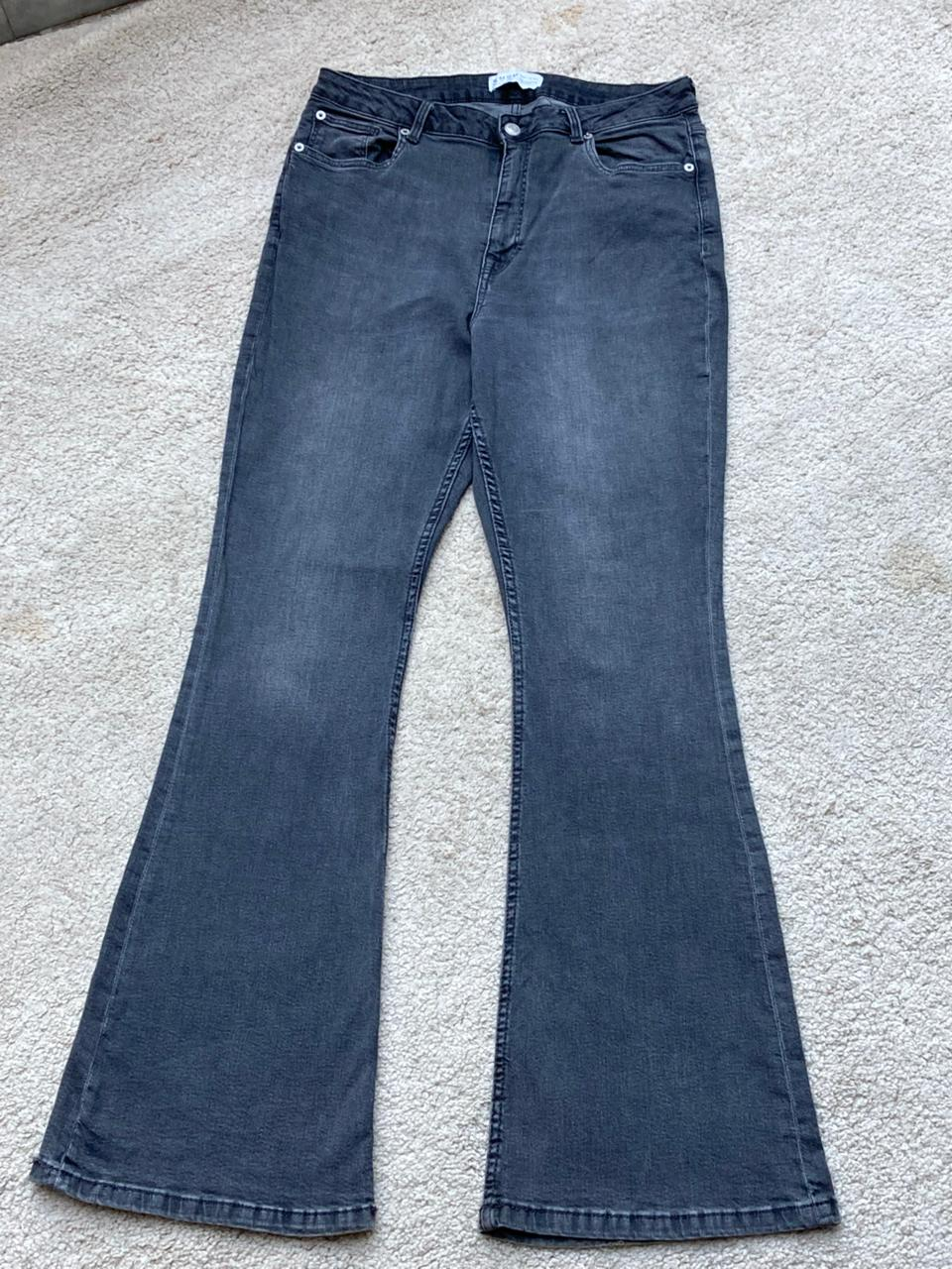 Original front photo of faded charcoal flared jeans