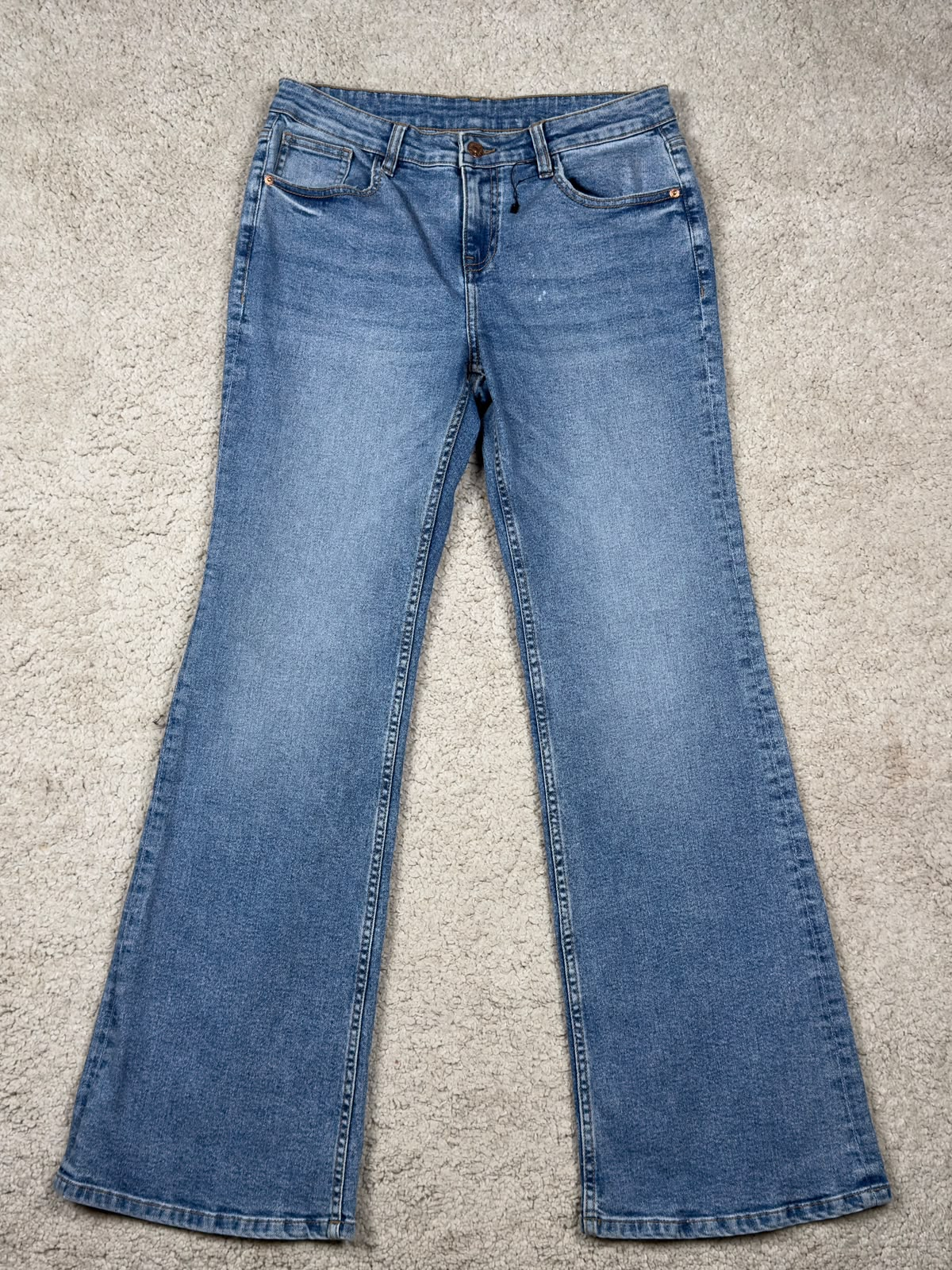 Mid-wash blue bootcut jeans, front view