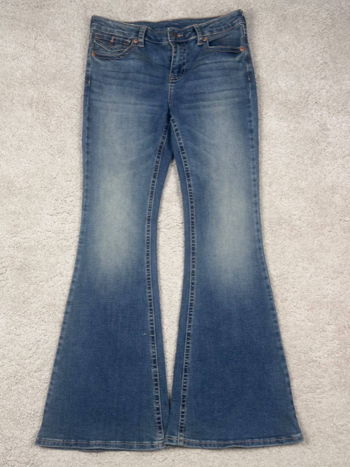 Washed black flared jeans, front view
